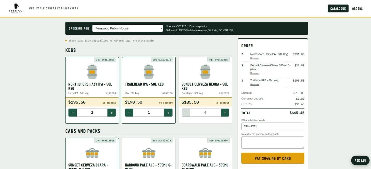 The order page: the licensee picked at the top with their licence and delivery address, the catalogue with live stock per product, and the order on the right with container deposit, GST, a PO number and the pay-by-card button.